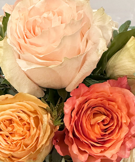 Rose Sorbet is a bubble bowl vase filled with sorbet colored roses and greenery